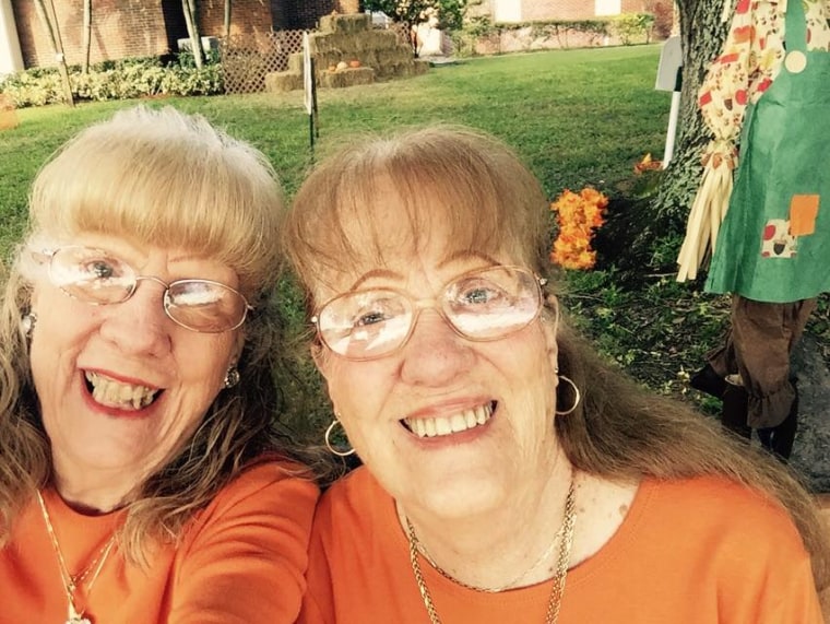 Twin women in orange