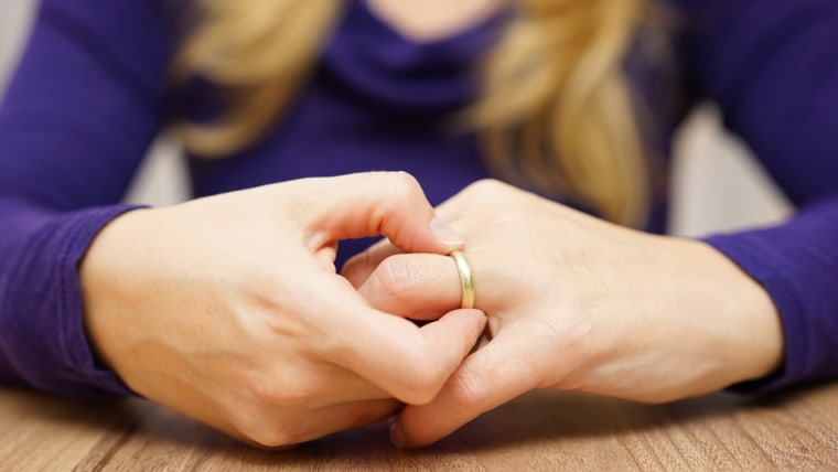 woman is taking off the wedding ring