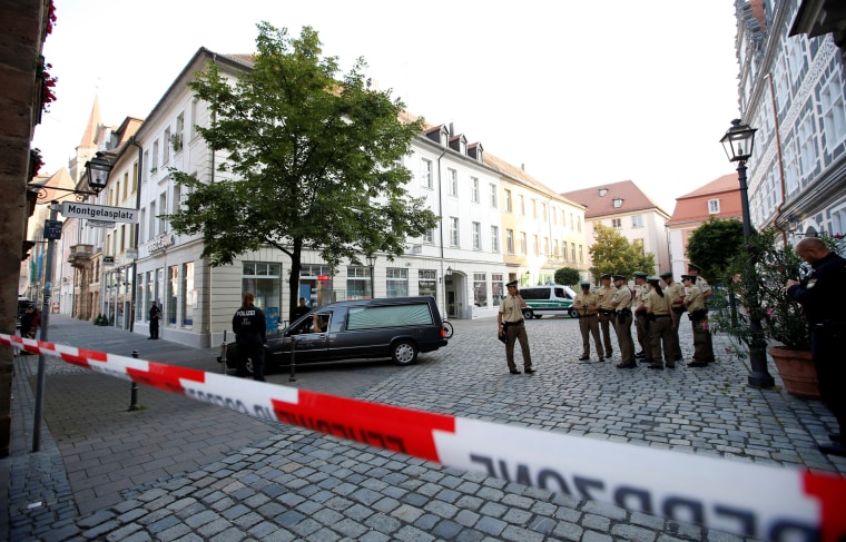 Image: A hearse leaves the area after an explosion in Ansbach