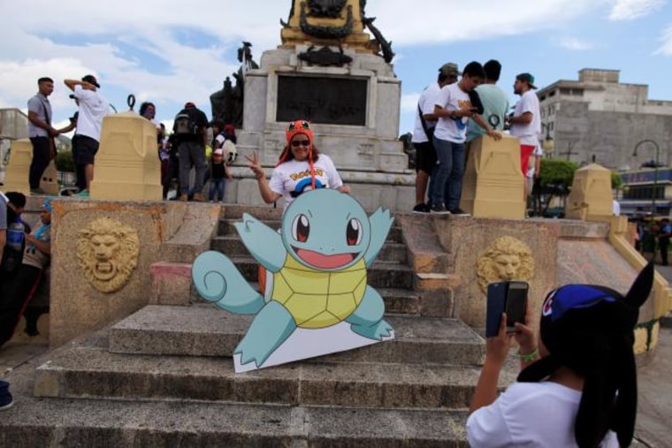 Fans of the augmented reality mobile game "Pokemon Go" by Nintendo participate in a "poketour" organized by the municipality in San Salvador