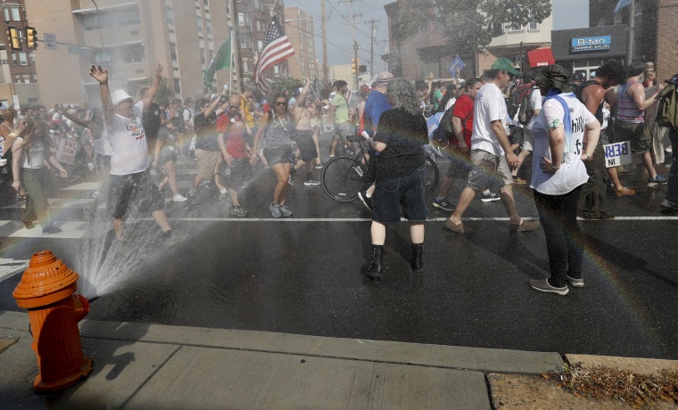 Image: Supporters of Sen. Bernie Sanders cool off at a fire hydrant