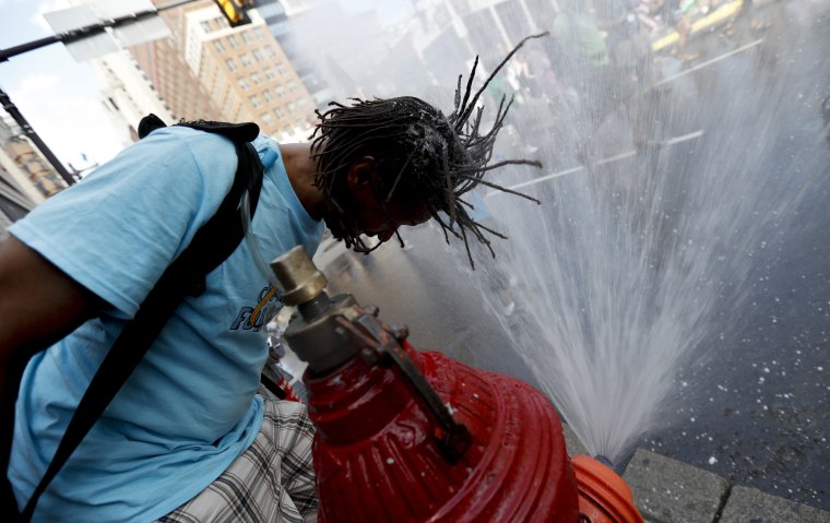 Image: A supporter of Sen. Bernie Sanders cools off during a march in downtown Philadelphia