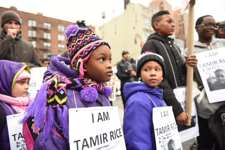 Kids with Tamir Rice signs. Stop Mass Incarcerations Network