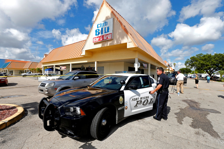 Image: A Fort Myers police officer is seen at a parking lot of Club Blu after a shooting in Fort Myers