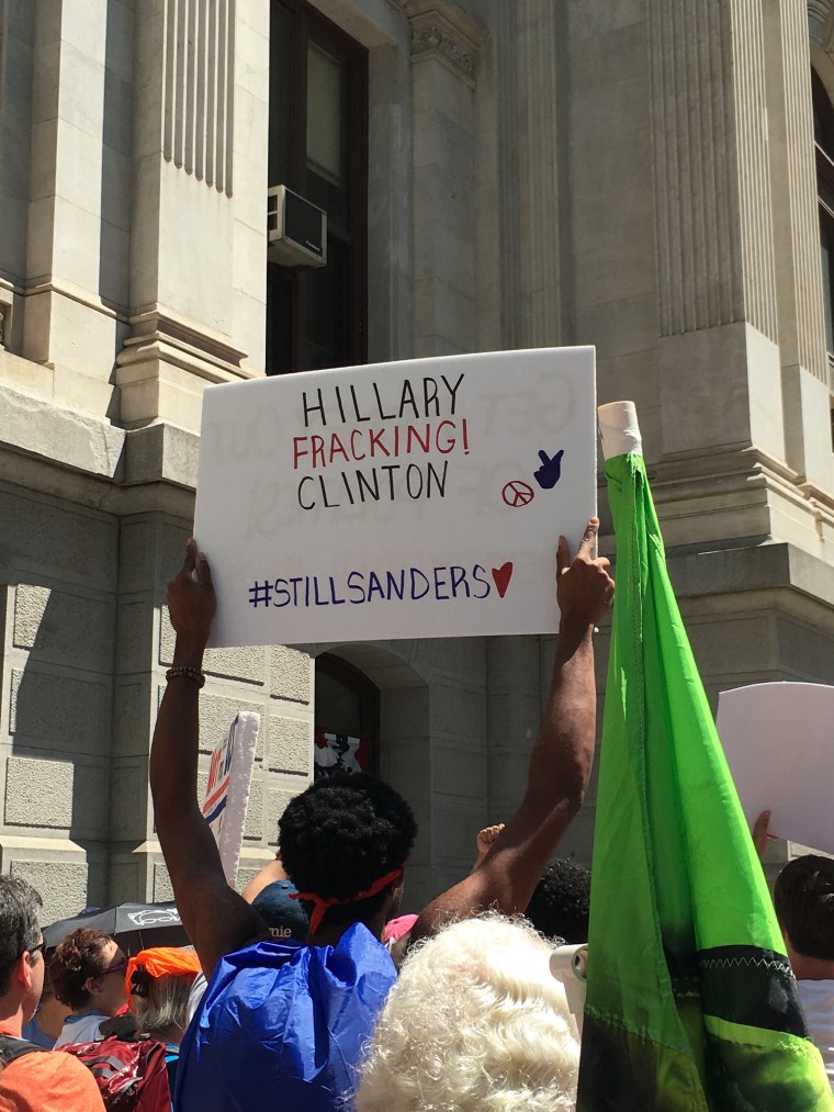 Signs protesting Hillary Clinton were common at Monday's pro-Sanders demonstrations.