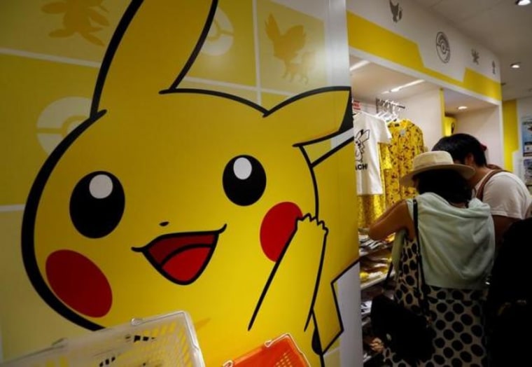 Customers look at goods of Pokemon at a shop in Tokyo