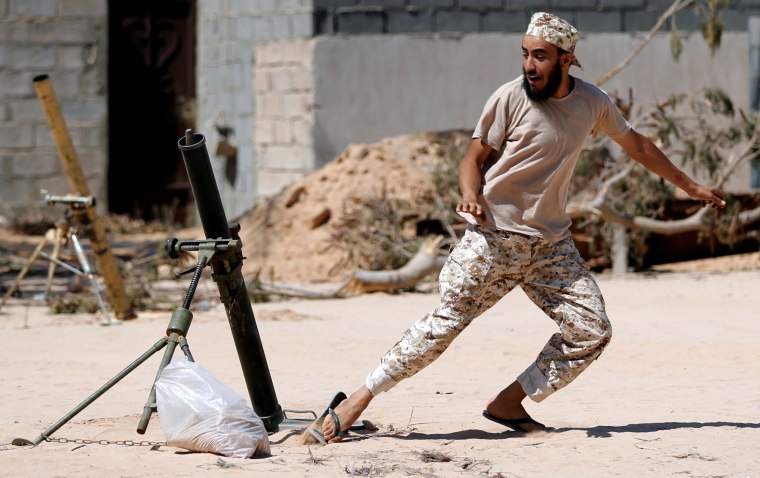 Image: A fighter of Libyan forces allied with the U.N.-backed government fires a 81 mm mortar round in Sirte