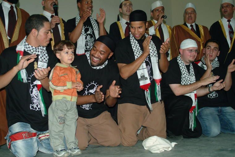 Native Deen meet with students during a trip with members of the U.S. State Department to a school in the Palestinian territories in 2006.