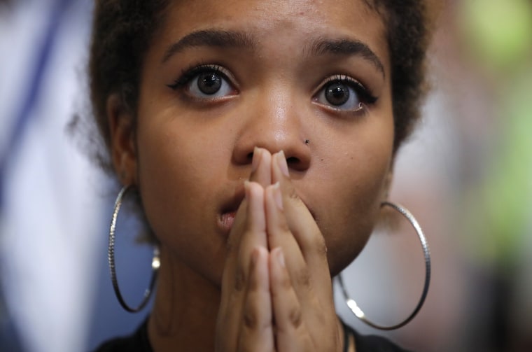 Image: A delegate clasps her hands together as she listens during the fourth and final night at the Democratic National Convention in Philadelphia