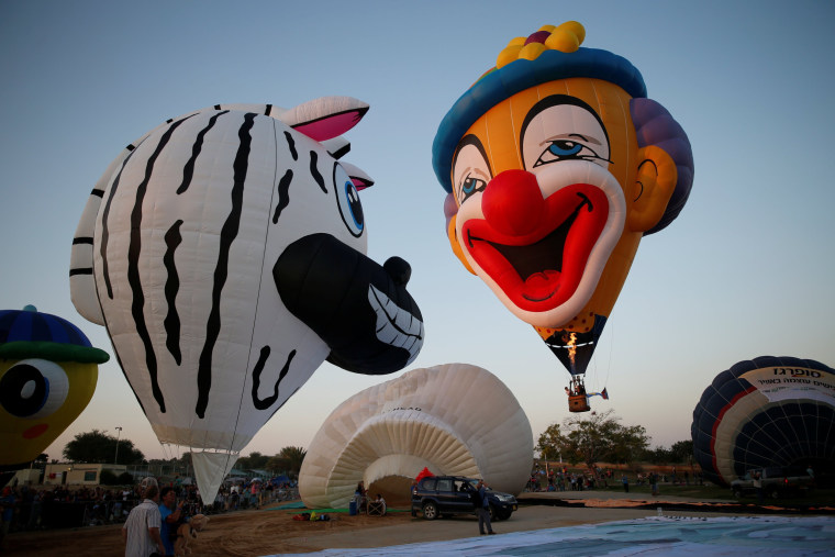 Image: Hot air balloons are prepared before they take flight during a two-day international hot air balloon festival in Eshkol Park near the southern city of Netivot