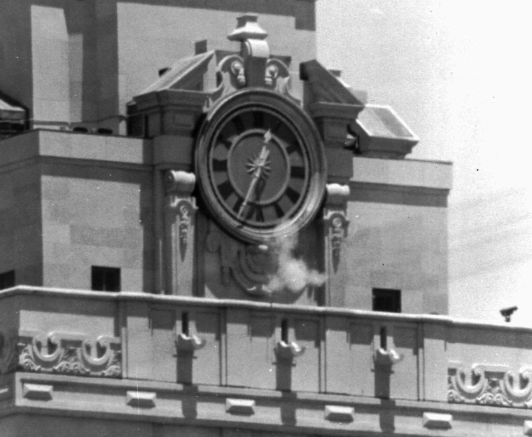 FILE: In this Aug. 1, 1966 file photo, smoke rises from the sniper's gun as he fired from the tower of the University of Texas administration building in Austin, Texas, on crowds below.