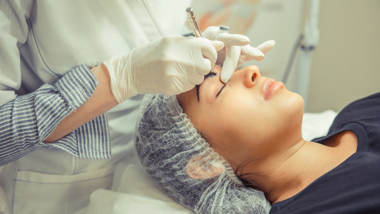 Woman having her eye brows tinted