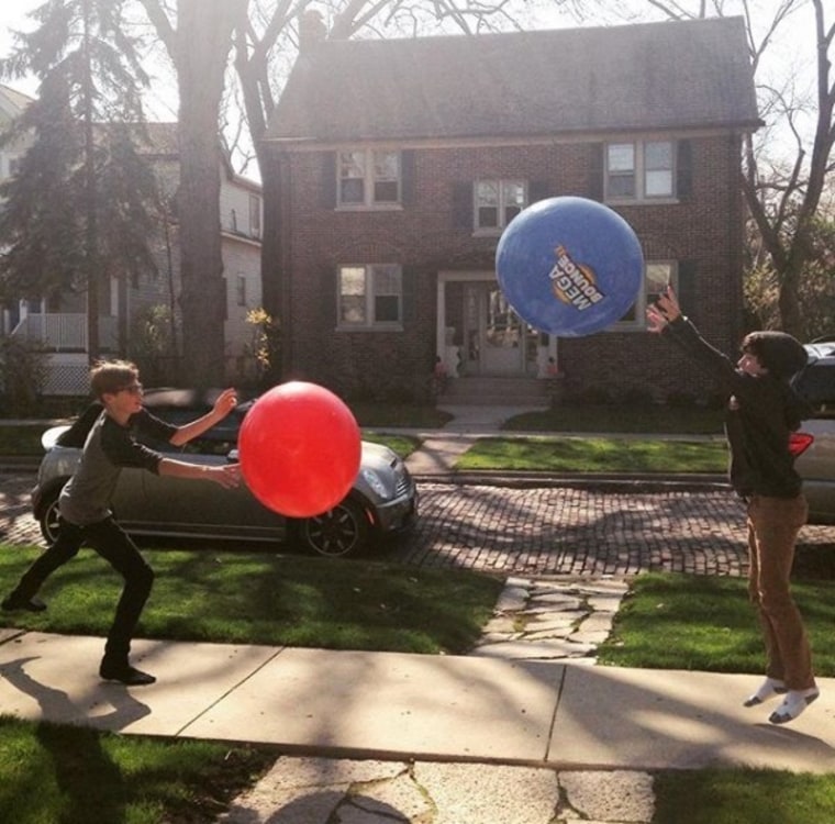 Kids bouncing a huge ball