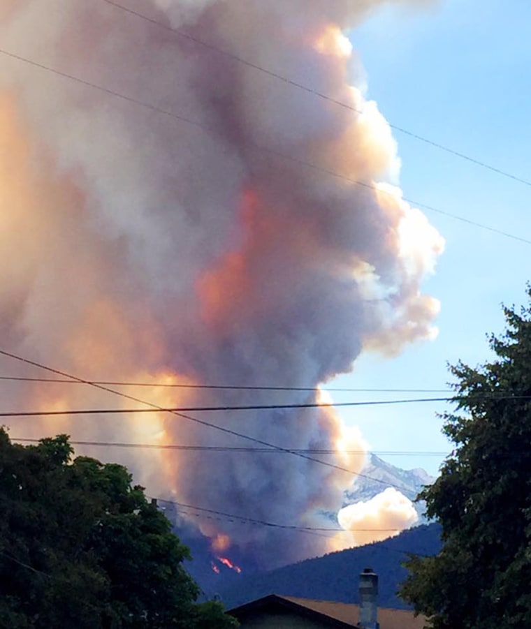 Image: Flames and smoke rise from the roaring Lion Wildfire