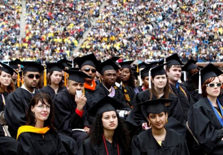 Graduating students listen to U.S. President Obama speak during commencement at the University of Michigan