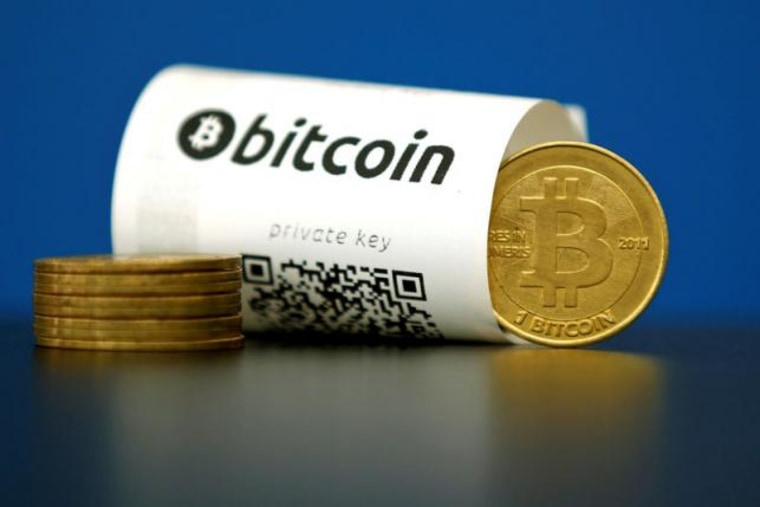 An illustration photo shows a Bitcoin (virtual currency) paper wallet with QR codes and a coin are seen at La Maison du Bitcoin in Paris