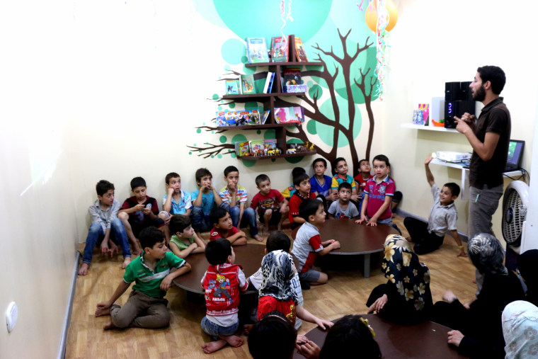 Children gather at Aleppo's underground children center.