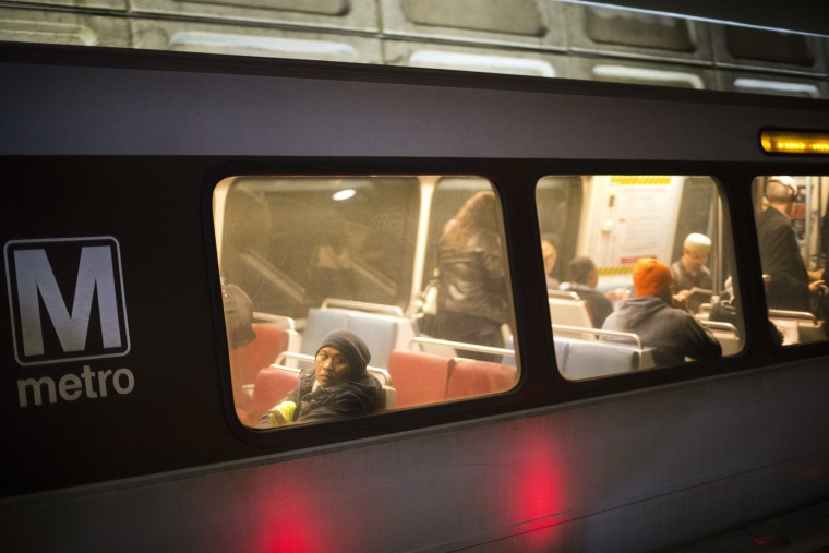 Passengers ride a Washington Metro subway train at the Chinatown Metro Station in Washington.