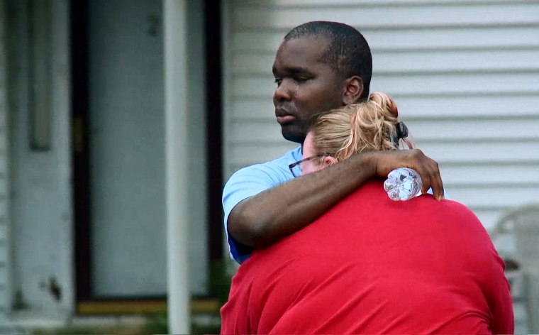 Kenneth Walker, a volunteer firefighter with the North Tonawanda, N.Y., Fire Department, embraces his wife, Amanda, at their home.