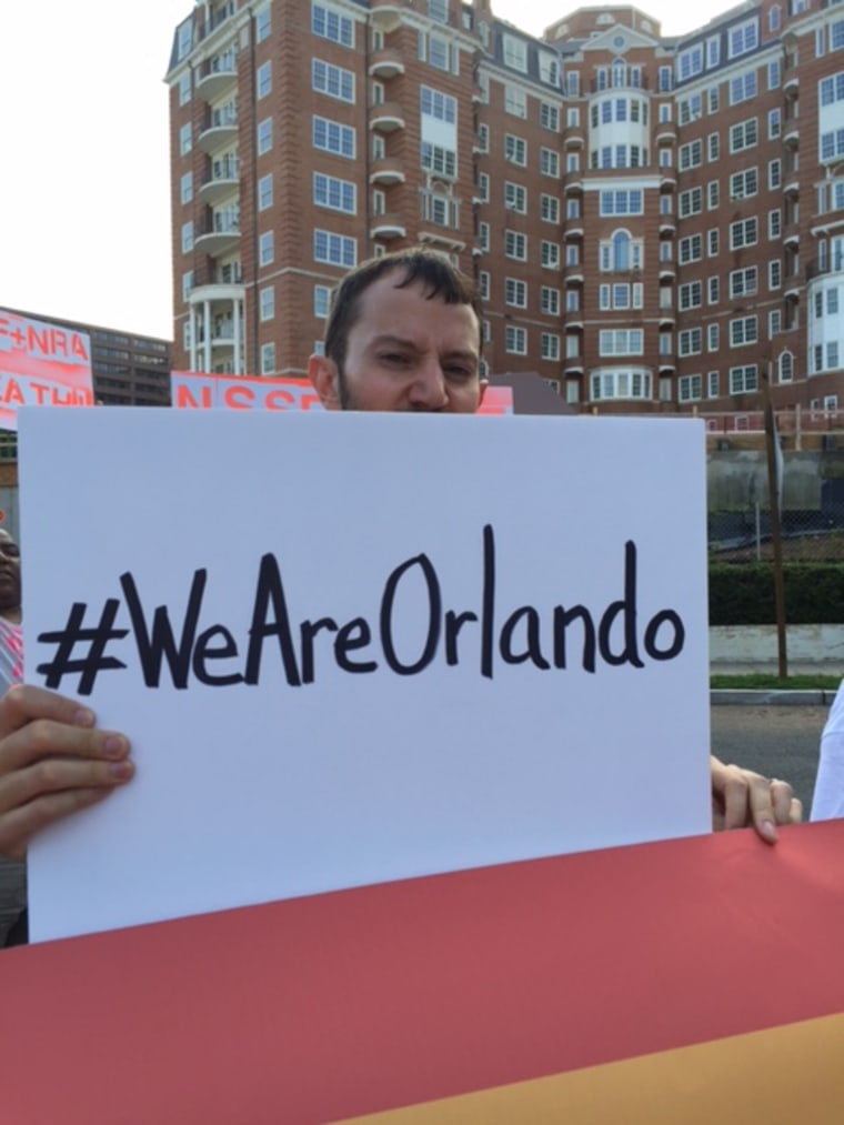 Protester holding a sign honoring the Orlando victims during a Gays Against Guns protest on Tuesday, August 2, 2016.