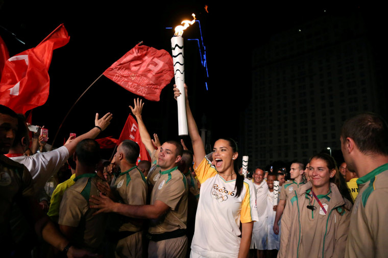Image: Model Adriana Lima carries the Olympic torch in Maua Square in Rio de Janeiro