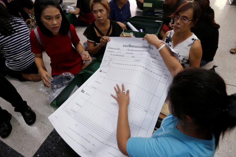 Image: Election Commission volunteers check voting materials and ballot boxes a day before the referendum on a new constitution at Ratchathewi district office in Bangkok