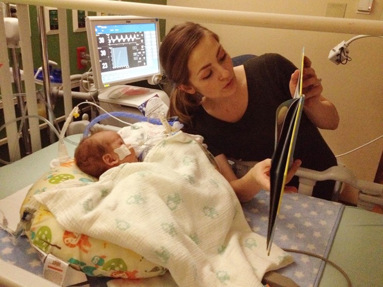 Demi Frandsen rading a book to Leo. Demi donated breast milk to honor her son.