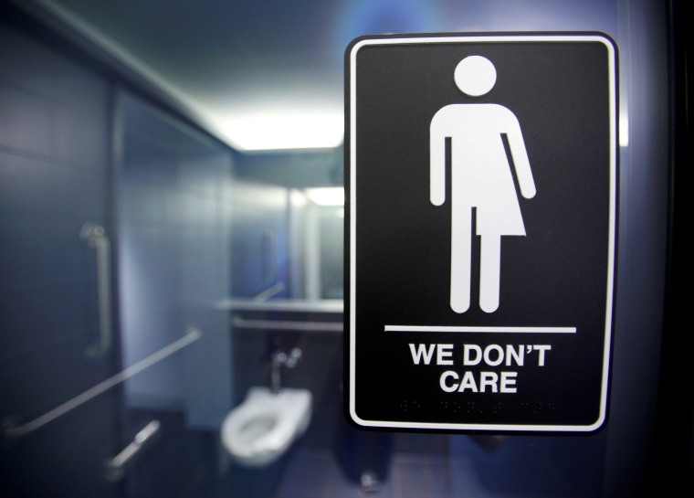 Image: A sign protesting a North Carolina law restricting transgender bathroom access is seen in the bathroom stalls