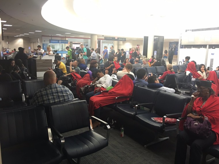 Image: At Los Angeles, passengers on late-evening redeye flights to the East Coast to were taken back to the terminal where they were still waiting for information at 3 a.m. PT.