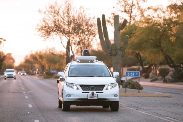 Test drivers use a Lexus SUV, built as a self-driving car, to map the area prior to a journey without a driver in control, in Phoenix