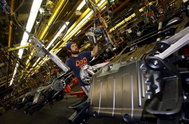 Jacob Bailey conducts assembly work on an SUV chassis at the General Motors Assembly Plant in Arlington, Texas