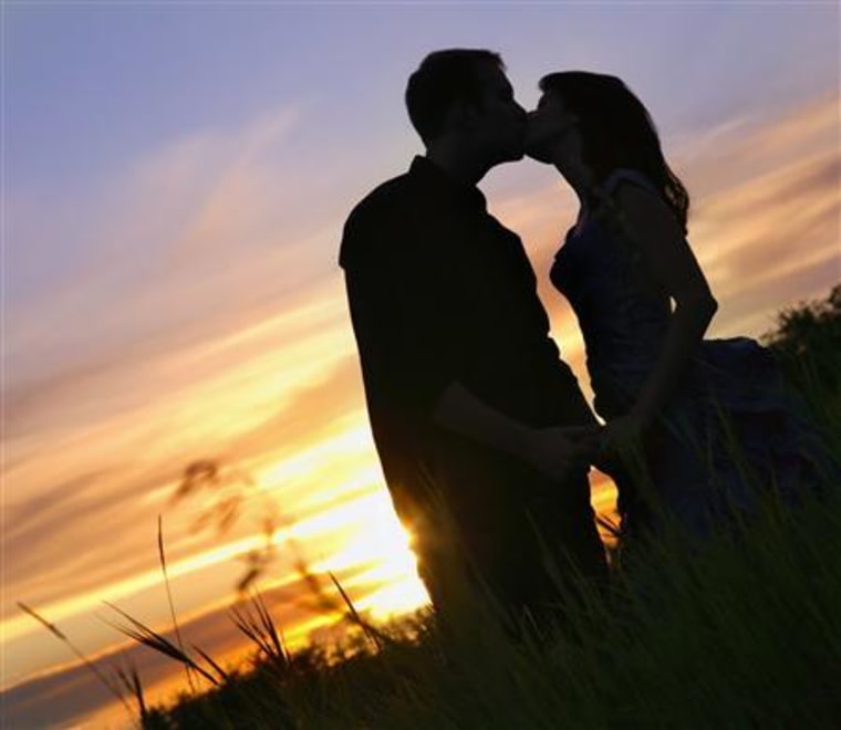 Silhouette Of A Couple Kissing