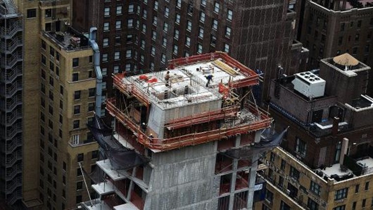 Construction laborers work on the top floor of a high rise apartment building in New York. Jewel Samad | AFP | Getty Images