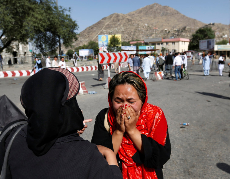 Image: An Afghan woman weeps at site of a suicide attack in Kabul, Afghanistan