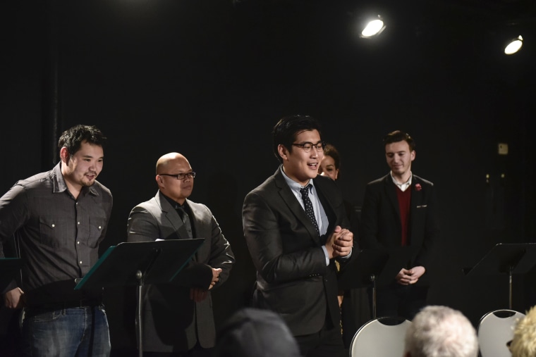 Dino Kim, center front, speaking at a workshop for his new off-Broadway musical, "Green Card," which premieres Aug. 12.