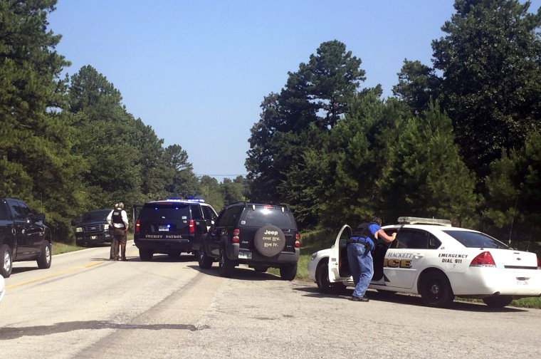 Law enforcement block an intersection during a stand off after two officers where shot in Sebastian County in Western Arkansas on Wednesday, Aug. 10, 2016. 