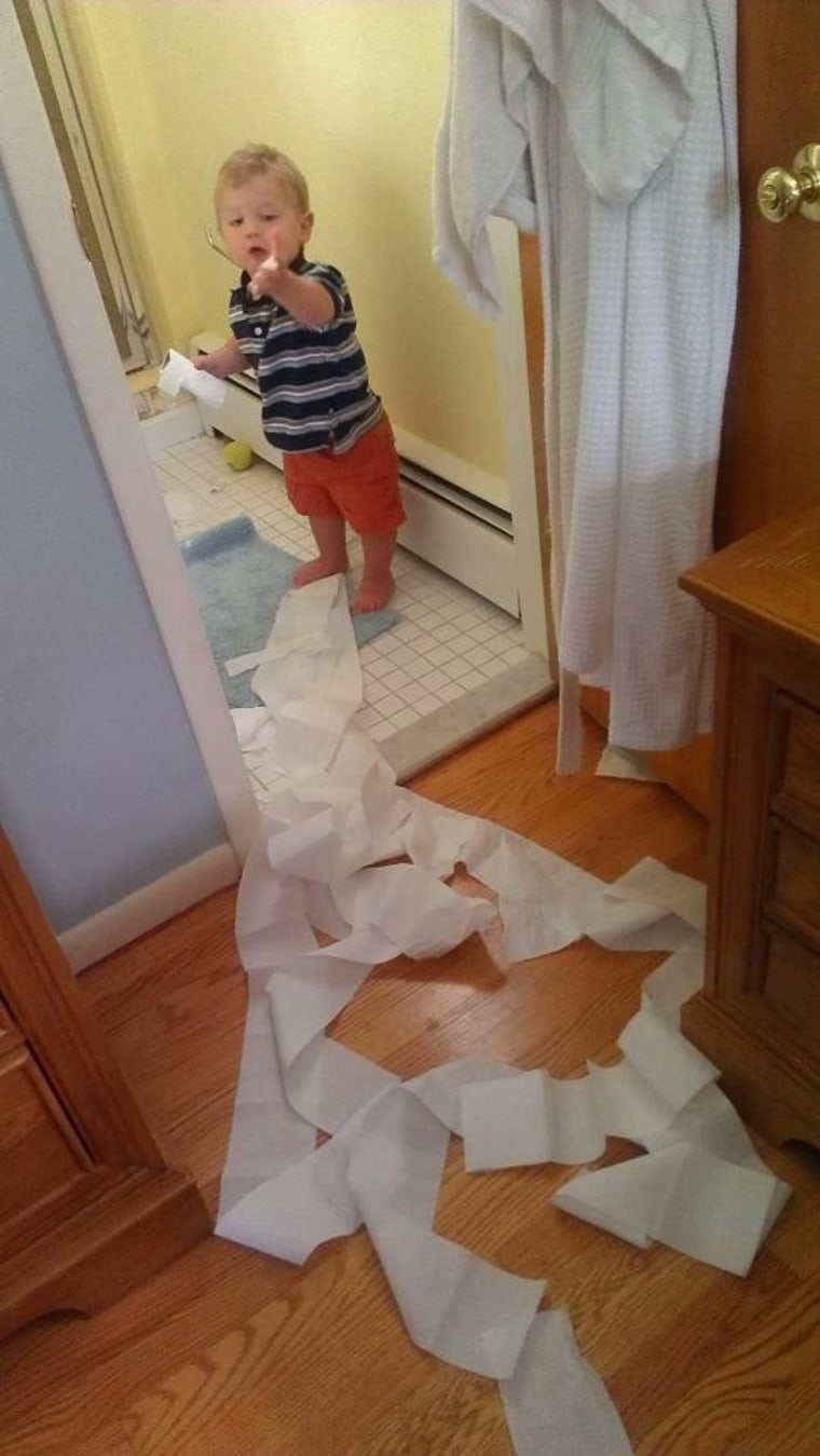 Little boy makes a big mess with toilet paper