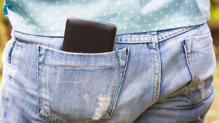 Mobile phone in the back pocket of blue jeans