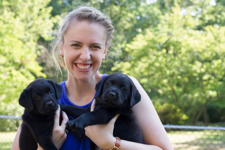 Puppy raiser Olivia Poff poses with dogs from the TODAY puppy's litter.