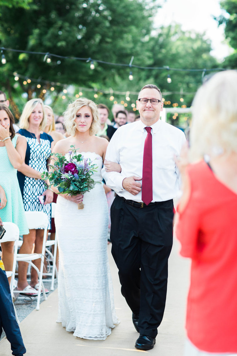 Bride Susie Lello comes down the aisle with her father, Anthony.