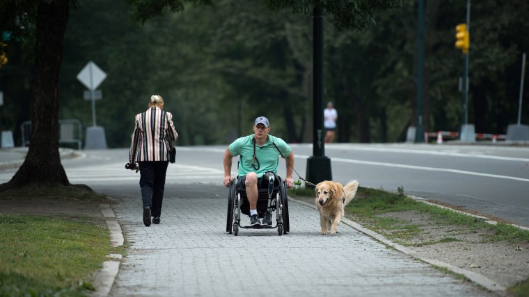 U.S. Navy Corpsman Joe Worley and his service dog, golden retriever Benjamin.