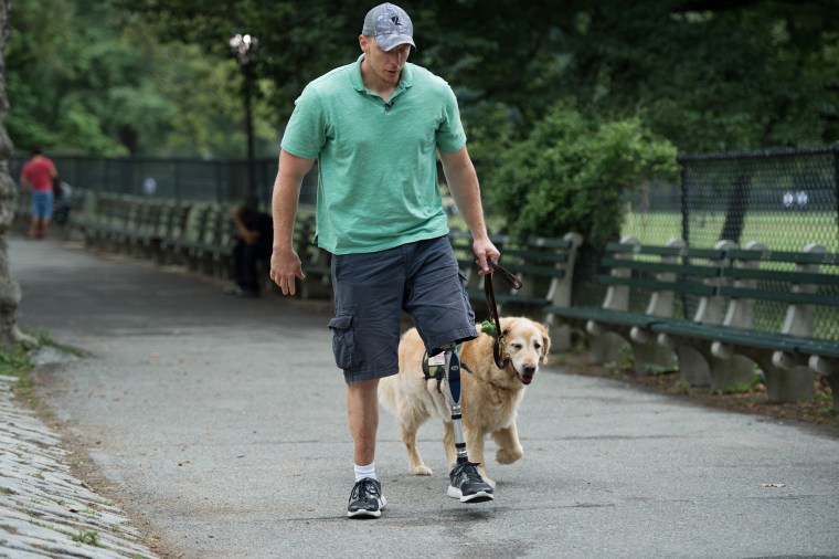 U.S. Navy Corpsman Joe Worley and his service dog, golden retriever Benjamin.