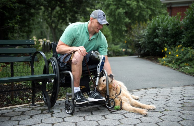 U.S. Navy Corpsman Joe Worley and his service dog, golden retriever Benjamin.