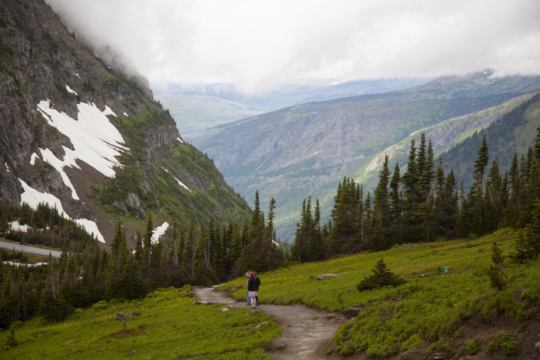 A family embarks on the Highline Trail from Logan's Pass in Glacier National Park.