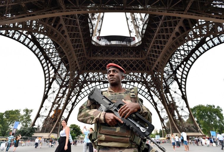 Image: French soldier patrols under Eiffel Tower on July 20, 2016