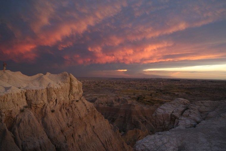 Image: Clouds are transformed by a sunset at Badlands National Park