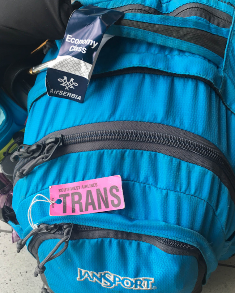 A photo of trans activist Hannah Simpson's backpack taken in August 2016. Just for fun, she ripped the "FER" off a Southwest Airlines "TRANSFER" tag and travels with it everywhere.