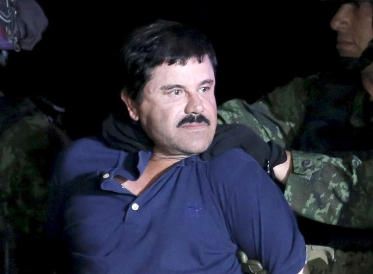 Image: Recaptured drug lord Joaquin "El Chapo" Guzman is escorted by soldiers during a presentation in Mexico City