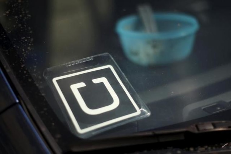 An Uber car is seen parked with the driver's lunch left on the dashboard in Venice, Los Angeles