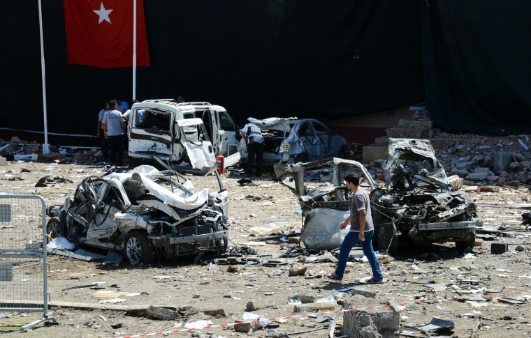 Image: Turkish rescue workers amid the wreckage of a bomb attack on a police station in Elazig, Thursday.
